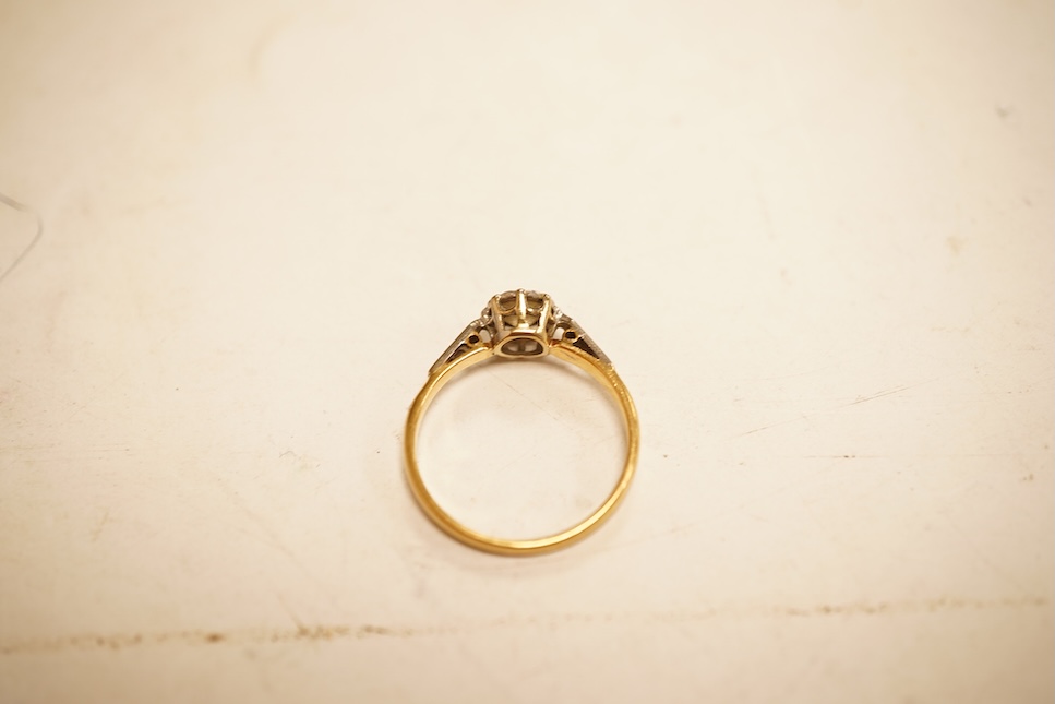 A modern yellow metal and single stone diamond set ring, with baguette and round cut diamond cluster set shoulders, total diamond weight approx. 0.50ct, size J/K (sizing spheres), gross weight 4.6 grams.